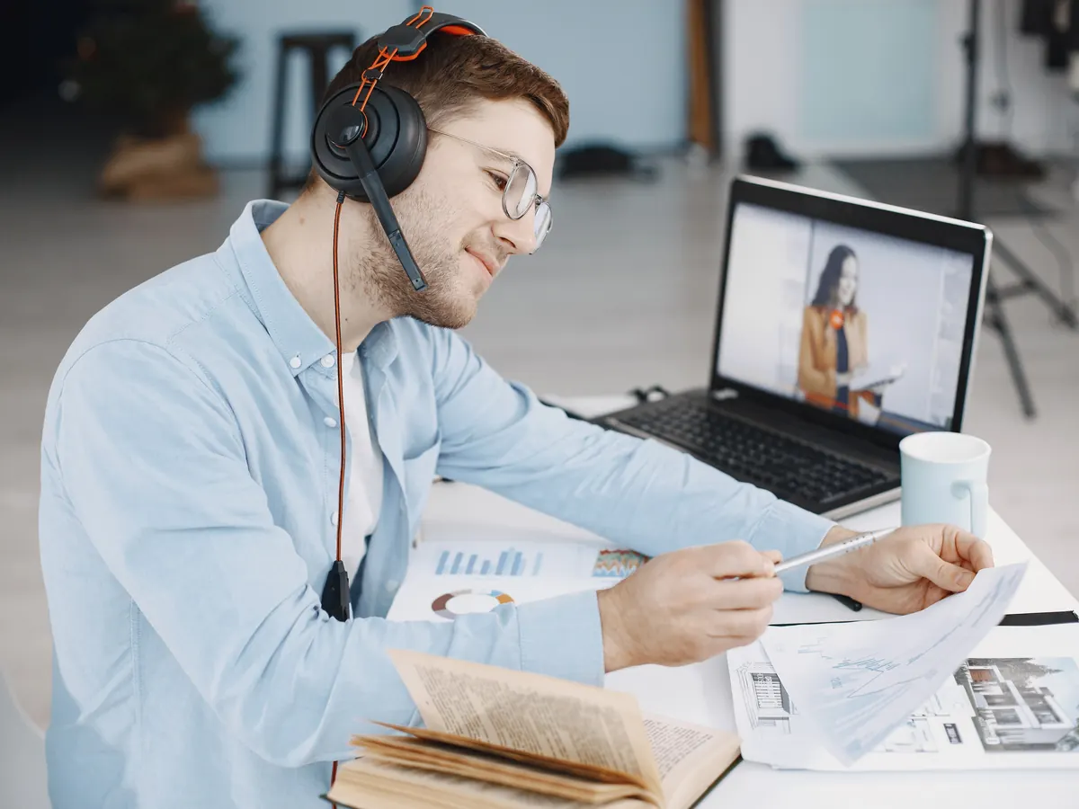 Consultant wearing a headset on a video call, reviewing a printed report at his desk, as in a free SEO audit walkthrough